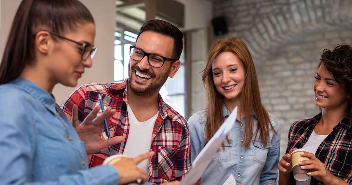 Four colleagues smiling in meeting